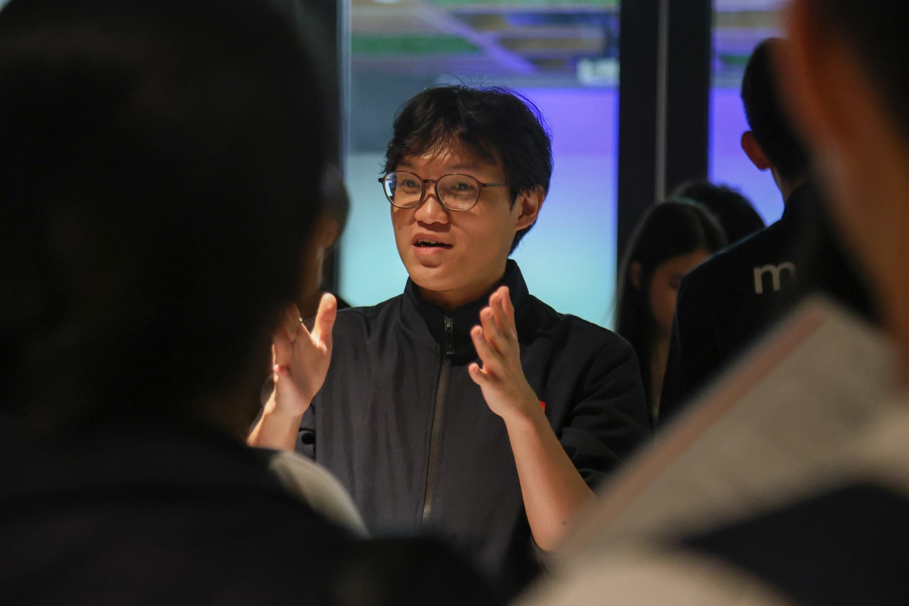 A MACRO teacher explaining a point at a past event